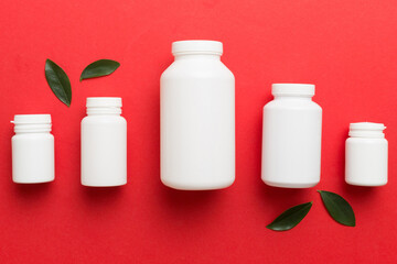 supplement pills with medicine bottle health care and medical top view. Vitamin tablets. Top view mockup bottle for pills and vitamins with green leaves, natural organic bio supplement, copy space