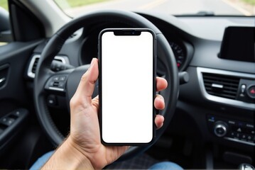A person is actively holding a cell phone in their hand while seated in a car