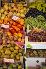 Fresh fruits and vegetables for sale at a market on Corfu, Greece, showcasing vibrant colors and local produce in a lively Mediterranean setting.
