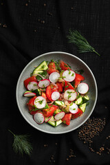 Fresh Vegetable Salad with Radishes and Tomatoes in Ceramic Bowl.