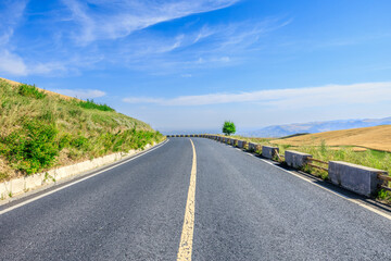 Empty asphalt road and mountains nature scenery in Xinjiang