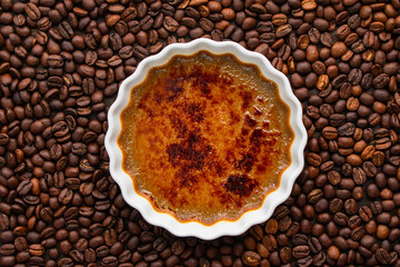 Coffee Creme Brulee Surrounded with Roasted Coffee Beans: Shallow ramekin of torched coffee creme brulee surrounded by whole coffee beans