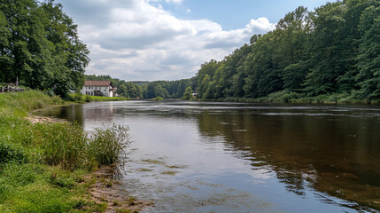 Fototapeta premium tranquil river scene with lush green trees and white house