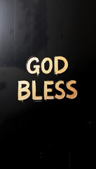 Golden lettering of the phrase God Bless painted on a black surface, creating a striking visual impact in an indoor setting
