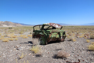 Abandoned Rusty Car in a Desert Landscape