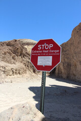 Warning Sign on Desert Trail: Extreme Heat Safety Alert