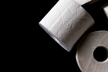 Roll of white toilet paper on a black background