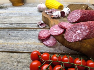 Wooden cutting board with sliced salami. High quality photo