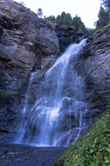 a waterfall is shown in the foreground .Cerler, Pyrenees of Huesca Spain