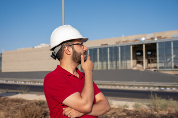 Construction Engineer in Hard Hat Observing Building Site