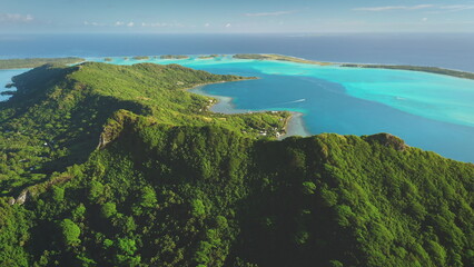 Breathtaking aerial view of Bora Bora island, vibrant turquoise water ocean lagoon and green...