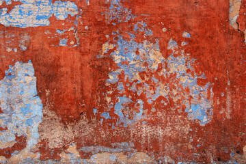 Old grunge wall with blue and red paint. Abstract background for design.