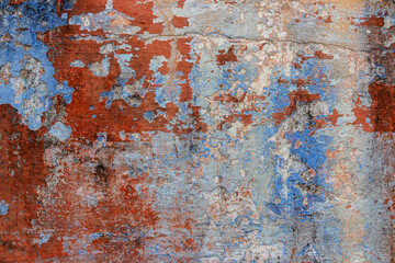 Old grunge wall with blue and red paint. Abstract background for design.