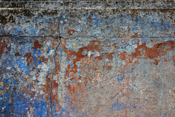 Old grunge wall with blue and red paint. Abstract background for design.