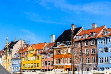 The famous Nyhavn area in the historical part of the city of Copenhagen with traditional houses and boats