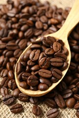 Сoffee beans in spoon, close up