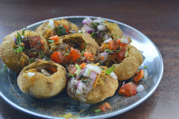 Pani puri served on a metal plate, a popular authentic local nepali street food, showing the traditional cuisine of Nepal