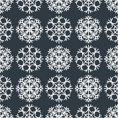 Seamless Christmas pattern of white geometric snowflakes on a gray background