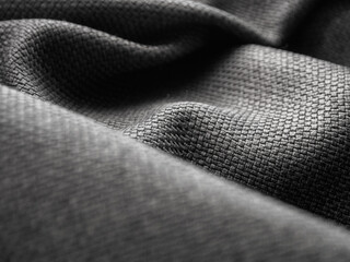 Macro photography of dark fabric, highlighting its texture and depth of color, creating an atmosphere of elegance and comfort