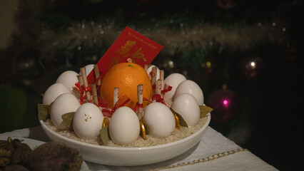 A Filipino prosperity bowl, a New Year belief and ritual to bring luck and wealth showing the...