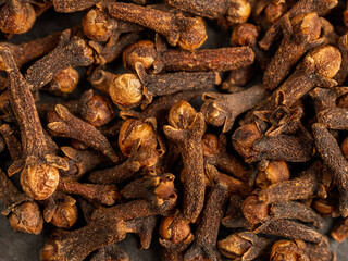 A close-up of aromatic cloves, highlighting the texture and rich color