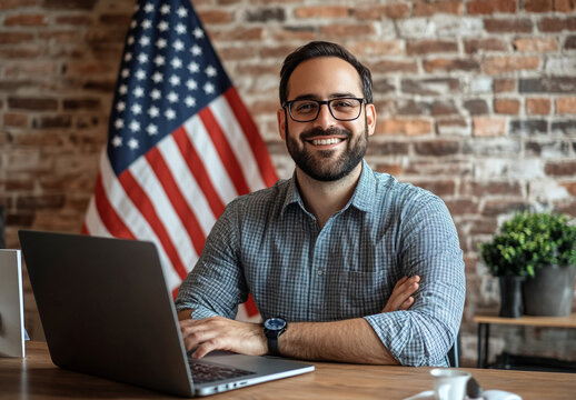 Businessman working on laptop with American flag.