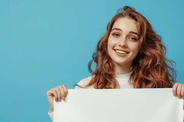 Naklejka premium Attractive girl showing copy space ad poster on blue background