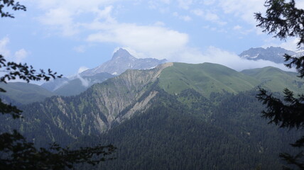 Majestic Mountain Peak With Snow and Clouds in Background