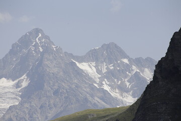 Majestic Mountain Peak With Snow and Clouds in Background