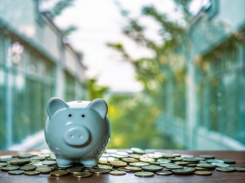 Piggy Bank and Coins on Table - Cute Savings Concept with Tilt-Shift Photography
