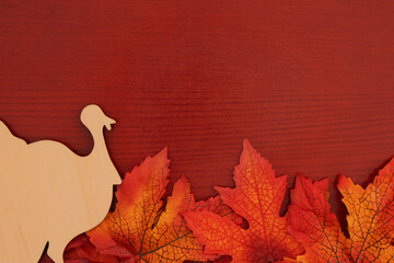 Fall leaves and turkey on red wood autumn background