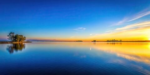 Fototapeta premium A peaceful scene of a clear blue sky at dusk with soft golden light, soft golden light, peaceful twilight, fading colors, gentle sunset, day ends