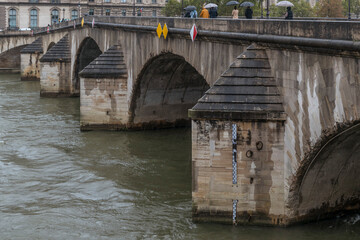 A rod with measurements in meters is applied to a pylon of the Pont Royal bridge in Paris, France,...