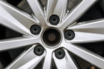 Background, texture of old, used titanium alloy wheel in car wheel. Close-up photo.