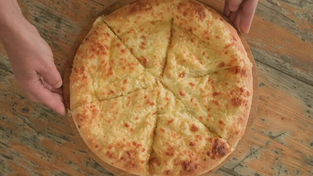 Serving Megrelian khachapuri, close-up, top view. Georgian food, Caucasian cuisine.