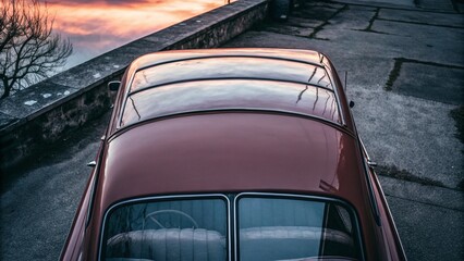Fototapeta premium Silhouette of a Red Vintage Car in Desenzano del Garda, Italy - Aerial Perspective on August 27, 2023