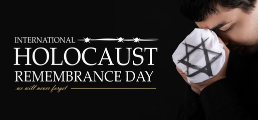 Jewish man honoring victims of Holocaust on dark background