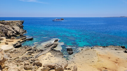 Turquoise waters off a rocky shore