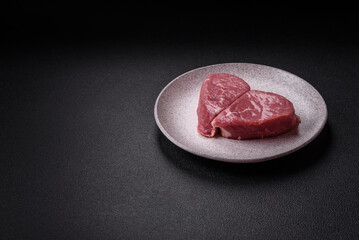 Ribeye steak raw with salt, spices and herbs