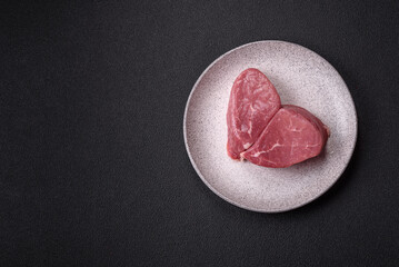 Ribeye steak raw with salt, spices and herbs