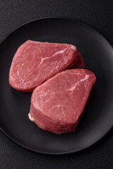 Ribeye steak raw with salt, spices and herbs