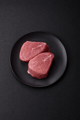 Ribeye steak raw with salt, spices and herbs