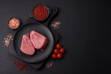 Ribeye steak raw with salt, spices and herbs