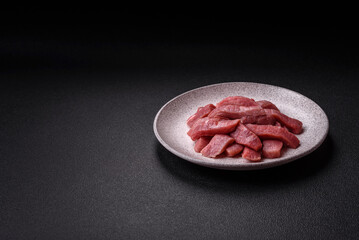 Juicy beef cut into slices with salt, spices and herbs