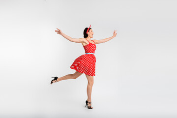 Fototapeta premium Full body photo of attractive woman dancing have fun enjoy holiday dressed red vintage style polka dot skirt isolated on white background