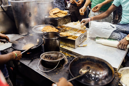 Indian men cook parathas