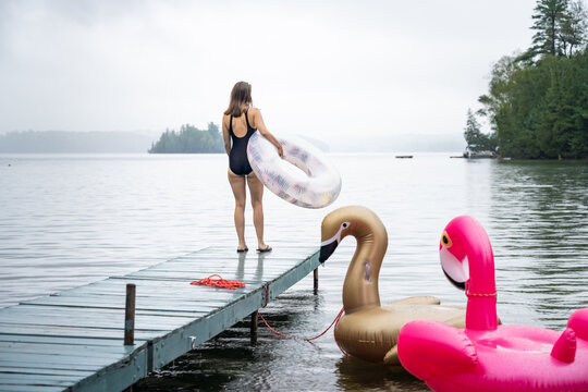 Young Woman Going for a Swim in the Rain at Summer Cottage Vacation