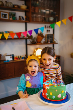 two happy girls at birthday table