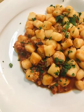 Delicious Italian Gnocchi Served With Savory Tomato Sauce 
