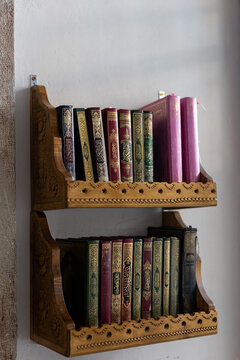 shelves in the mosque filled with a Quran